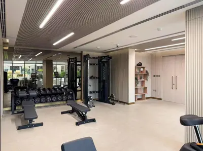 a gym with chairs and equipment in a building at SettlerHomes - Chic JVC Studio - Pool & Clubhouse in Dubai