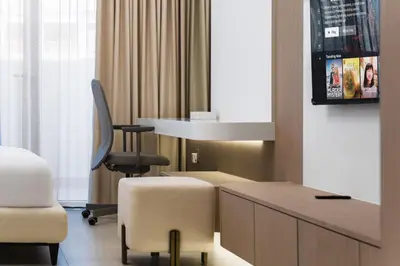 a room with a desk and a chair and a desk and a chair at SettlerHomes - Chic JVC Studio - Pool & Clubhouse in Dubai