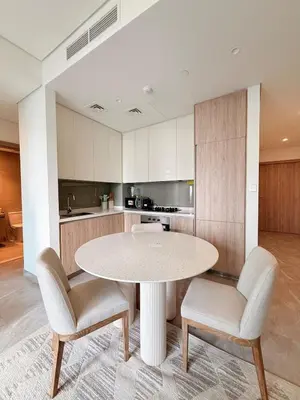 a kitchen with a round table and two chairs at Luxurious view of the Business Bay canal, 2 beds in Dubai