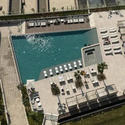 an overhead view of a swimming pool with chairs and tables at Luxurious view of the Business Bay canal, 2 beds in Dubai