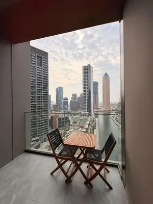 a table and chairs on a balcony with a view of a city at Luxurious view of the Business Bay canal, 2 beds in Dubai