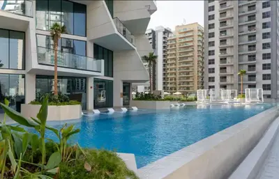 a swimming pool in the middle of a building at Vogue JVC Binghatti Phantom near Circle Mall, One Bedroom Apartment with a Private Pool in Balcony and full Access to all Amenities in Dubai