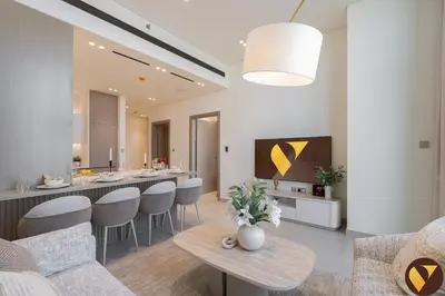 a kitchen and living room with a table and chairs at Vogue JVC Binghatti Phantom near Circle Mall, One Bedroom Apartment with a Private Pool in Balcony and full Access to all Amenities in Dubai