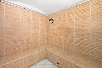 a large bathroom with a large brick wall at Lake Point Tower 1 BHK by Petals Holiday Homes in Dubai