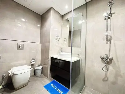 a bathroom with a shower and a toilet and a sink at Merano Tower 1BHK in Business Bay By Petals Holiday Homes in Dubai