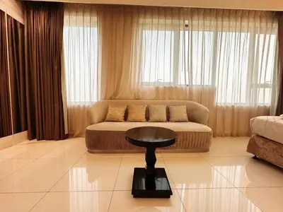 a living room with a couch and a table at Capital Bay Studio in Business Bay by Petals Holiday Homes in Dubai