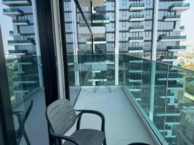 two chairs sitting on a balcony in a building at 1 Residence 1BHK near Metro by Petals Holiday Homes in Dubai