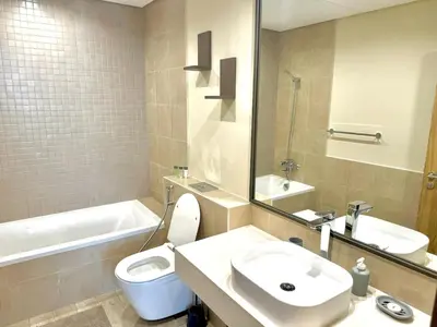 a bathroom with a sink and a toilet and a tub at 1 Residence 1BHK near Metro by Petals Holiday Homes in Dubai