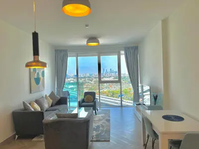 a living room with a view of a city at 1 Residence 1BHK near Metro by Petals Holiday Homes in Dubai