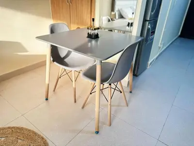 a dining room table with two chairs and a table at Cordoba Palace Studio In Silicon Oasis by Petals Holiday Homes in Dubai