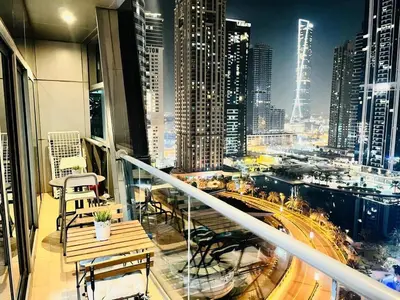 a balcony with a view of a city at night at Indigo Tower 1 BR in JLT by Petals Holiday Homes in Dubai
