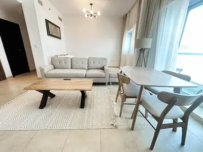 a living room with a couch and a table at preatoni tower 1 BHK in JLT By petals Holiday Homes in Dubai