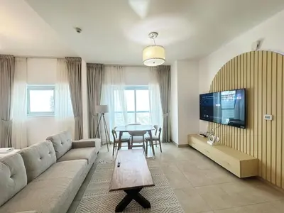 a living room with a couch and a table at preatoni tower 1 BHK in JLT By petals Holiday Homes in Dubai