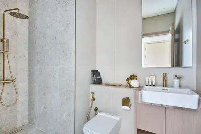 a bathroom with a toilet and a sink and a shower at Frank Porter - Binghatti Phantom in Dubai