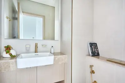 a bathroom with a white sink and a mirror at Frank Porter - Binghatti Phantom in Dubai