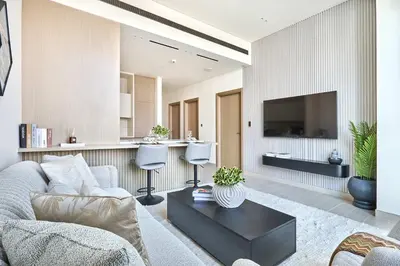 a living room with a couch and a tv at Frank Porter - Binghatti Phantom in Dubai