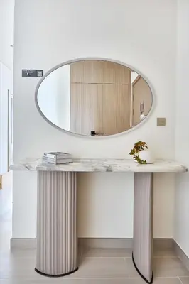 a dressing table with a round mirror on top at Frank Porter - Binghatti Phantom in Dubai