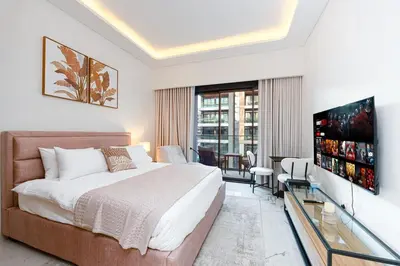 a hotel room with a bed and a television at Modern Std Near Burj Khalifa with Pool and City Views in Dubai