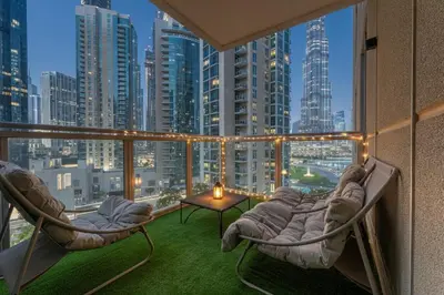 a balcony with chairs and a view of a city at HAVN - 2 Bed in The Residences, Burj Khalifa View in Dubai