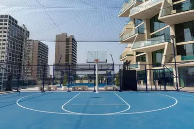 a basketball court in a city with a basketball hoop at Luxury 1BR in JVC Private Balcony Pool & Parking in Dubai