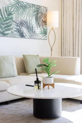 a living room with a coffee table and a couch at Luxury 1BR on Palm Jumeirah with Pool Access and Beach in Dubai