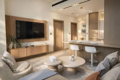 a living room with a couch and a table at Stylish Escape 1BR Plunge Pool & Pool View in Dubai