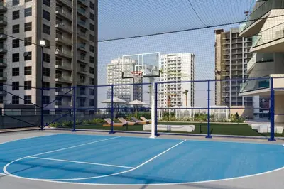 a tennis court in the middle of a city at Stylish Escape 1BR Plunge Pool & Pool View in Dubai