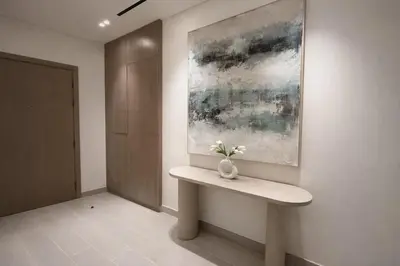 a vase of flowers sitting on a bench in a room at Stylish Escape 1BR Plunge Pool & Pool View in Dubai
