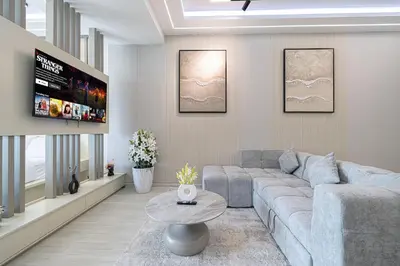 a living room with a couch and a table at 3BHK Near Beach High Floor Marina Stay DEC 1203 Tower 1 in Dubai
