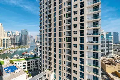 an aerial view of a tall building next to a river at 3BHK Near Beach High Floor Marina Stay DEC 1203 Tower 1 in Dubai