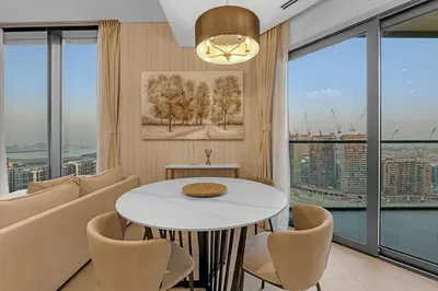 a living room with a couch and a table at Waves - Elegant High-Floor 2BR Close To Downtown in Dubai