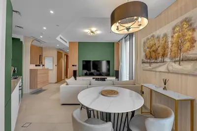 a living room with a couch and a table at Waves - Elegant High-Floor 2BR Close To Downtown in Dubai
