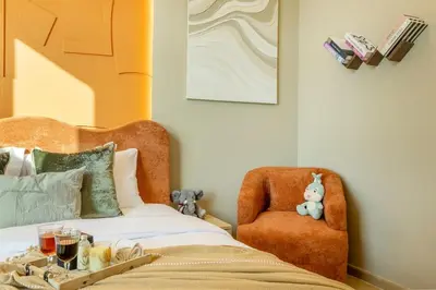 a bedroom with a bed and a chair and a table at Stylish 2BHK Central Marina Rooftop Pool DEC T1 601 in Dubai