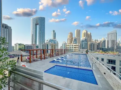 a pool on the roof of a building with a city skyline at Stylish 2BHK Central Marina Rooftop Pool DEC T1 601 in Dubai