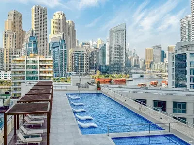 a pool on the roof of a building with a city at Stylish 2BHK Central Marina Rooftop Pool DEC T1 601 in Dubai