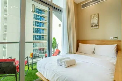 a bedroom with a bed and a large window at Luxury 2BHK w Floating Bed in Dubai Marina DEC 1604 in Dubai