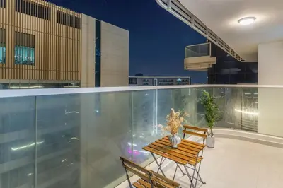 a balcony with a table and chairs on a building at Luxury 1 BHK in Al Barsha by Opalz by Danube 1607 in Dubai