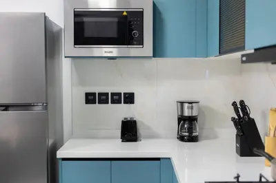a kitchen with a microwave above a kitchen counter at Luxury 1 BHK in Al Barsha by Opalz by Danube 1607 in Dubai