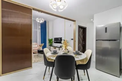 a kitchen and dining room with a table and chairs at Luxury 1 BHK in Al Barsha by Opalz by Danube 1607 in Dubai