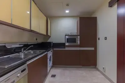 a kitchen with a sink and a microwave at 2BHK in Palm Jumeirah Sea View Grandeur Residence 301 in Dubai