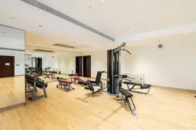 a gym with a lot of treadmills and machines at 2BHK in Palm Jumeirah Sea View Grandeur Residence 301 in Dubai
