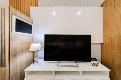 a flat screen tv sitting on top of a white cabinet at New Bright Studio in Escan Tower, For 2, Dubai Marina in Dubai