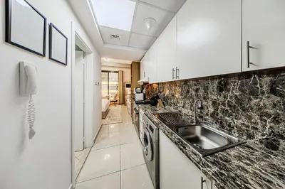 a kitchen with a sink and a counter top at New Bright Studio in Escan Tower, For 2, Dubai Marina in Dubai