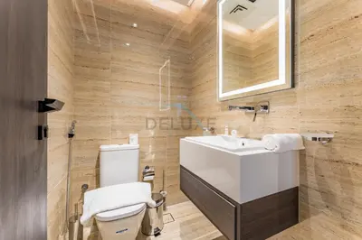 a bathroom with a white sink and a toilet at Community View 1BR, Perfectly Located Near the Park, Just a Short Drive Away from Dubai Top Tourist Attractions, Adhara Star, Arjan by Deluxe Holiday Homes in Dubai