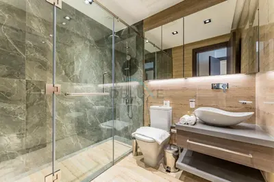 a bathroom with a shower and a toilet and a sink at Community View 1BR, Perfectly Located Near the Park, Just a Short Drive Away from Dubai Top Tourist Attractions, Adhara Star, Arjan by Deluxe Holiday Homes in Dubai