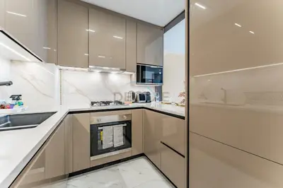 a kitchen with a sink and a stove at Community View 1BR, Perfectly Located Near the Park, Just a Short Drive Away from Dubai Top Tourist Attractions, Adhara Star, Arjan by Deluxe Holiday Homes in Dubai