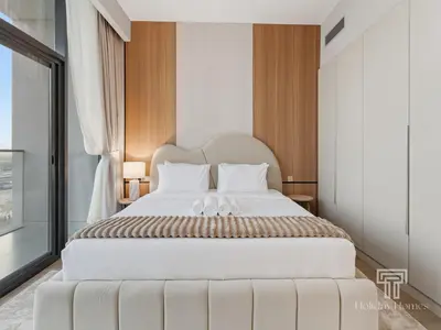 a bedroom with a large white bed with white pillows at Brand New 2 Bed Contemporary Apt-Gym Pool Access in Dubai