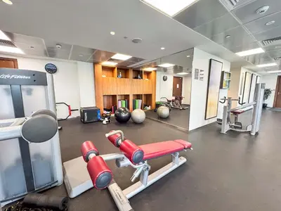 a gym with two red boxing machines in a room at PVH - Acacia C - Spacious 1BR with Direct Dubai Hills Park Access in Dubai