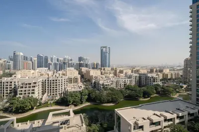 an aerial view of a city with buildings and a river at Greens Haven City & Golf View Balcony in Dubai