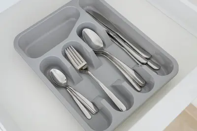 a tray with silver utensils sitting on a counter at Greens Haven City & Golf View Balcony in Dubai
